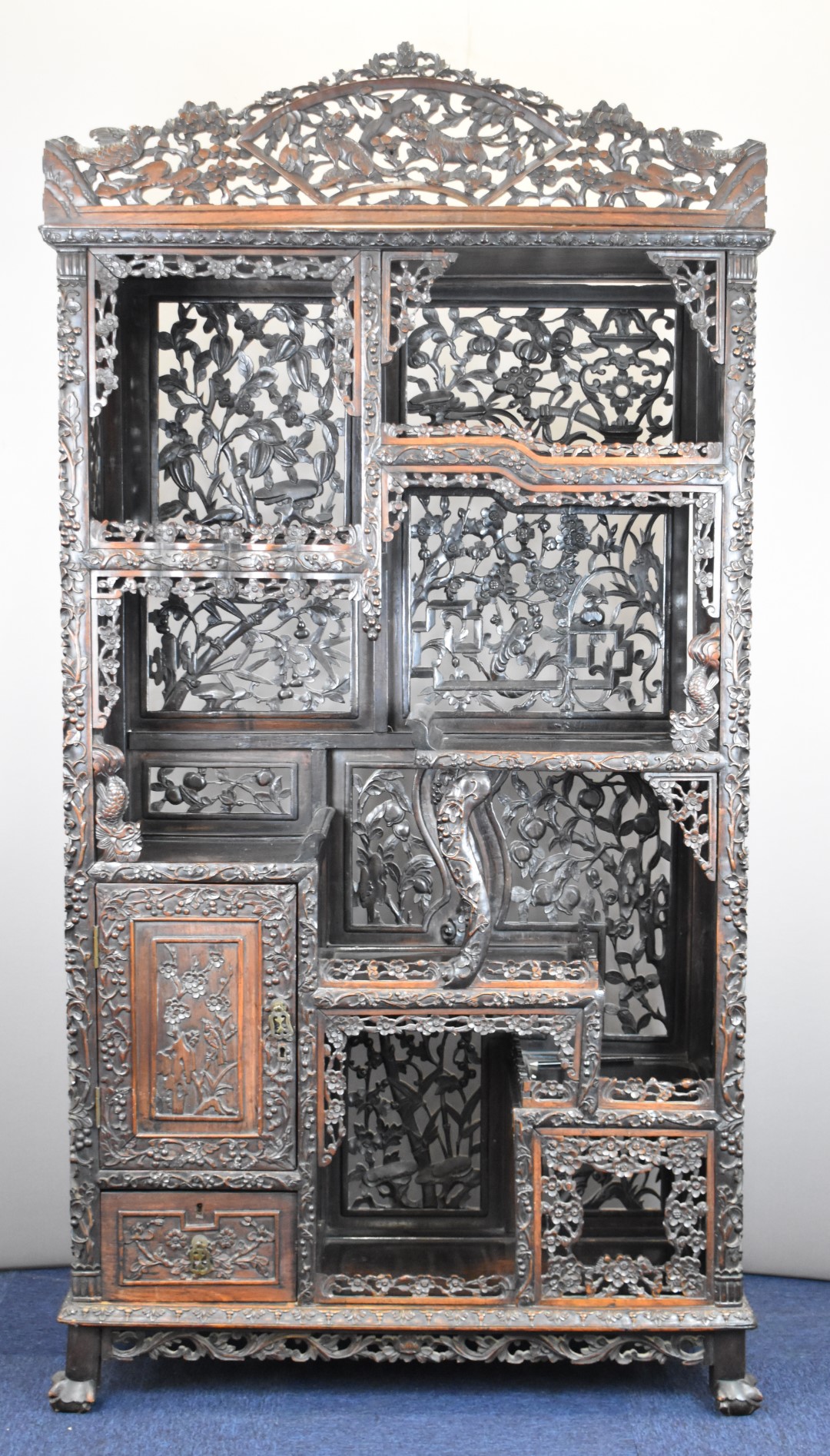 19th / 20thC Chinese carved wood cabinet with an arrangement of tiered and stepped shelves and