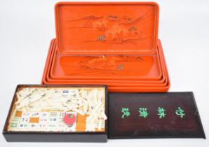 Mahjong set in box and a set of five Japanese stacking lacquer trays, largest 25 x 29cm