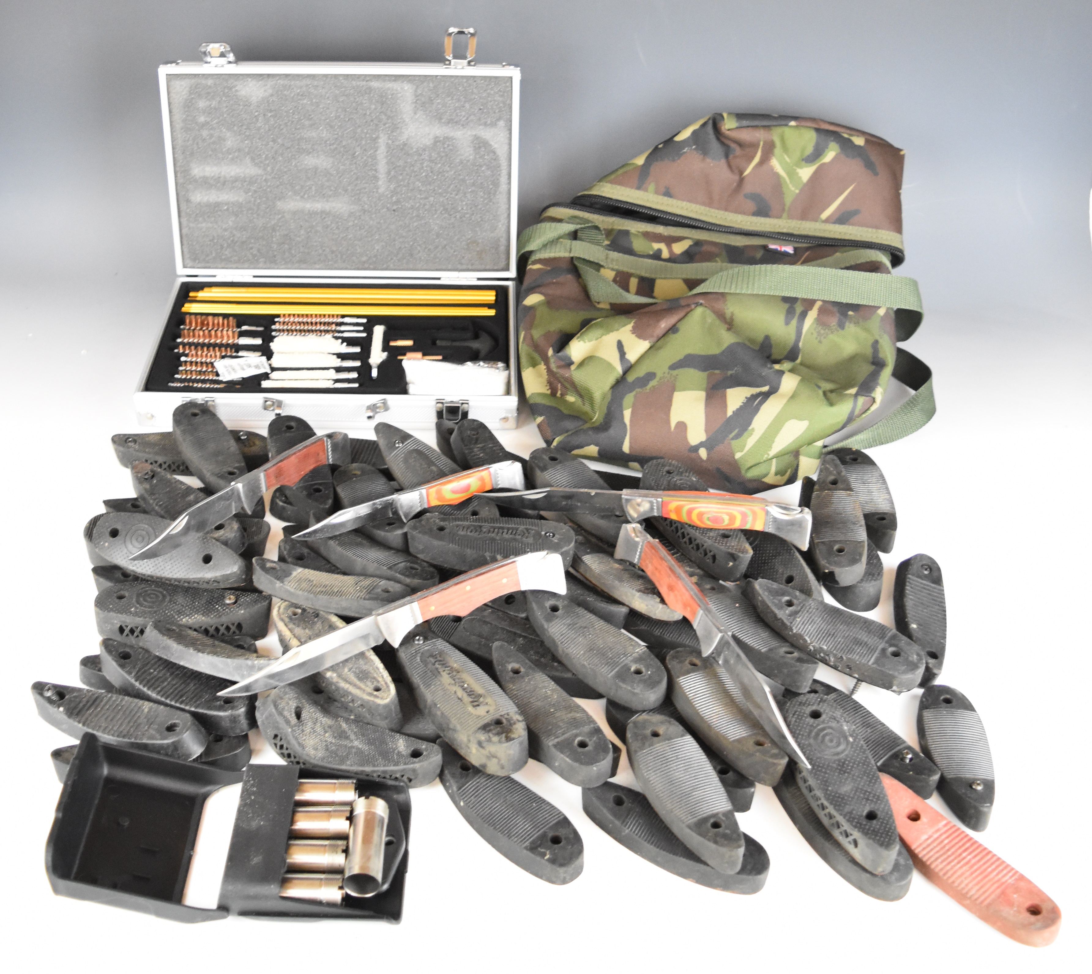 A collection of gun accessories including Midwater PCP cylinder carry bag, recoil pads, shotgun