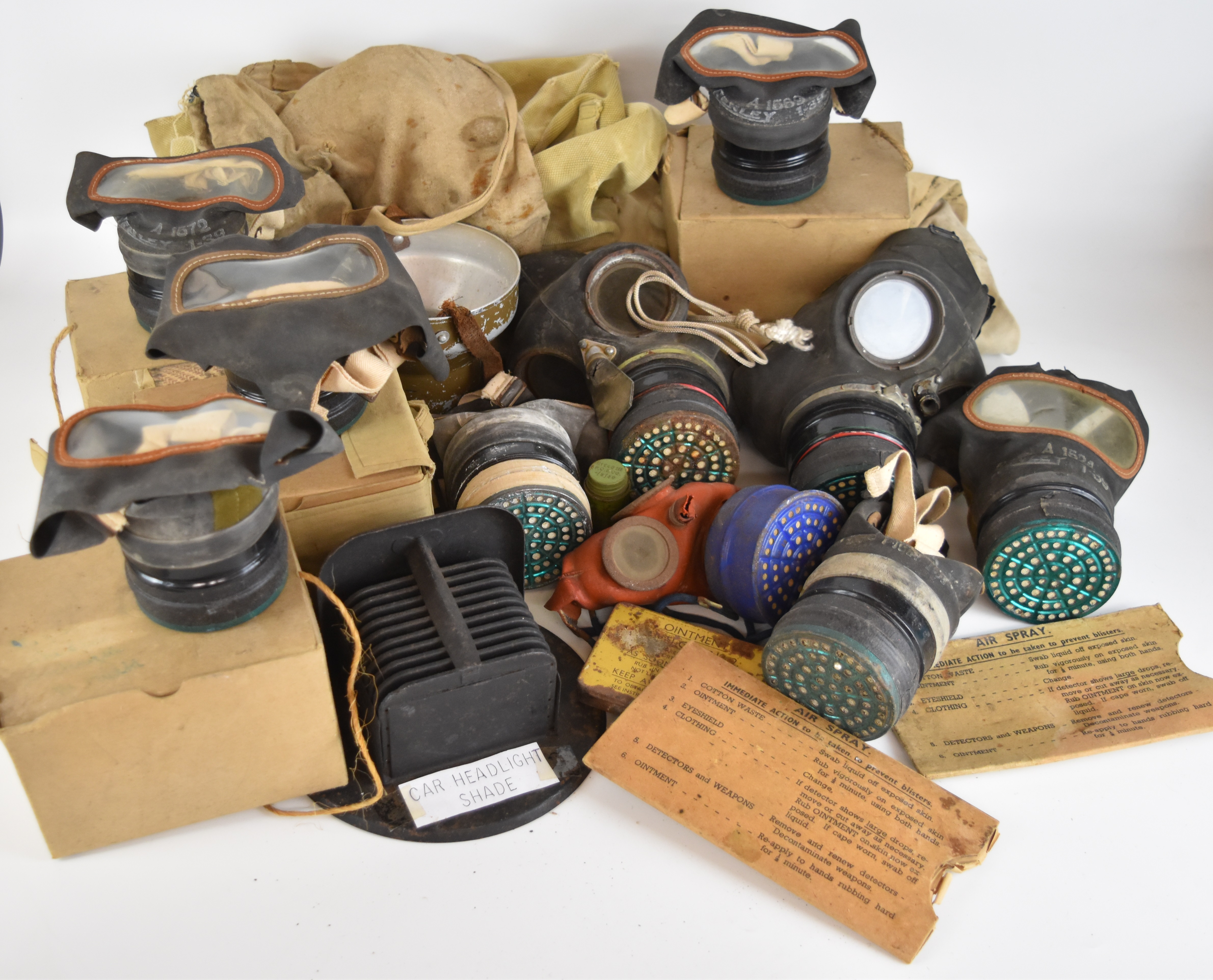 Ten various British WW2 gas masks / respirators including a child's example with metal storage tin