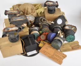 Ten various British WW2 gas masks / respirators including a child's example with metal storage tin