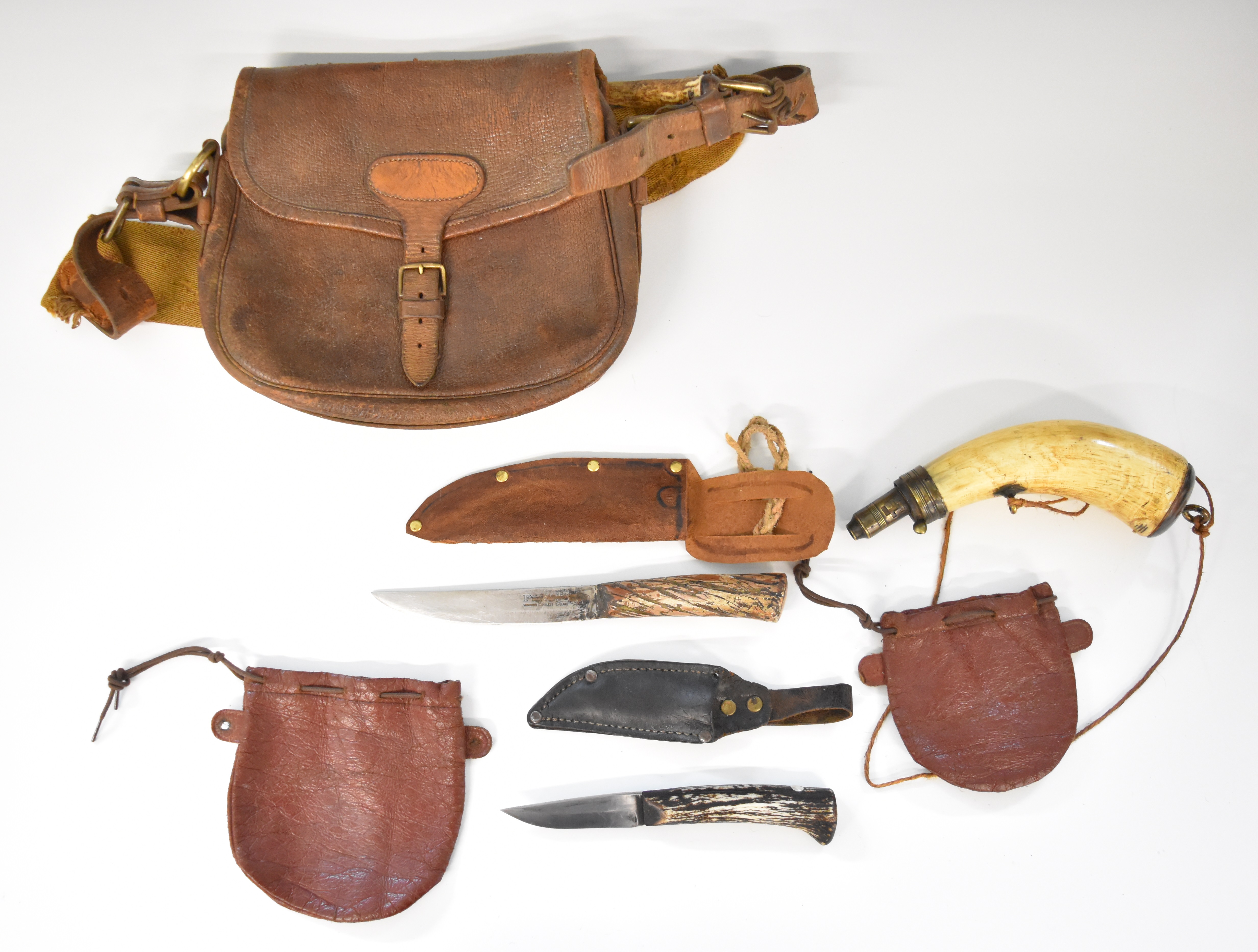 Leather Possibles bag with various hand made accessories including flint or bullet pouches, powder