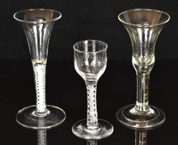 Three Georgian clear drinking glasses, one with cotton twist stem, one with air twist stem and the
