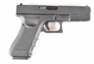 W E Tactical 9x19 airsoft pistol with textured composite grip and fixed sights, serial number
