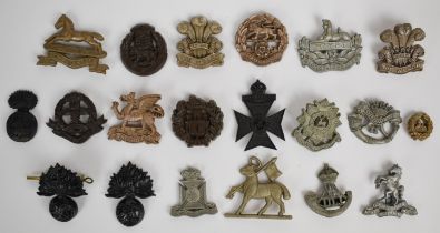 Twenty British Army plastic economy badges including West Yorkshire Regiment with F & G to