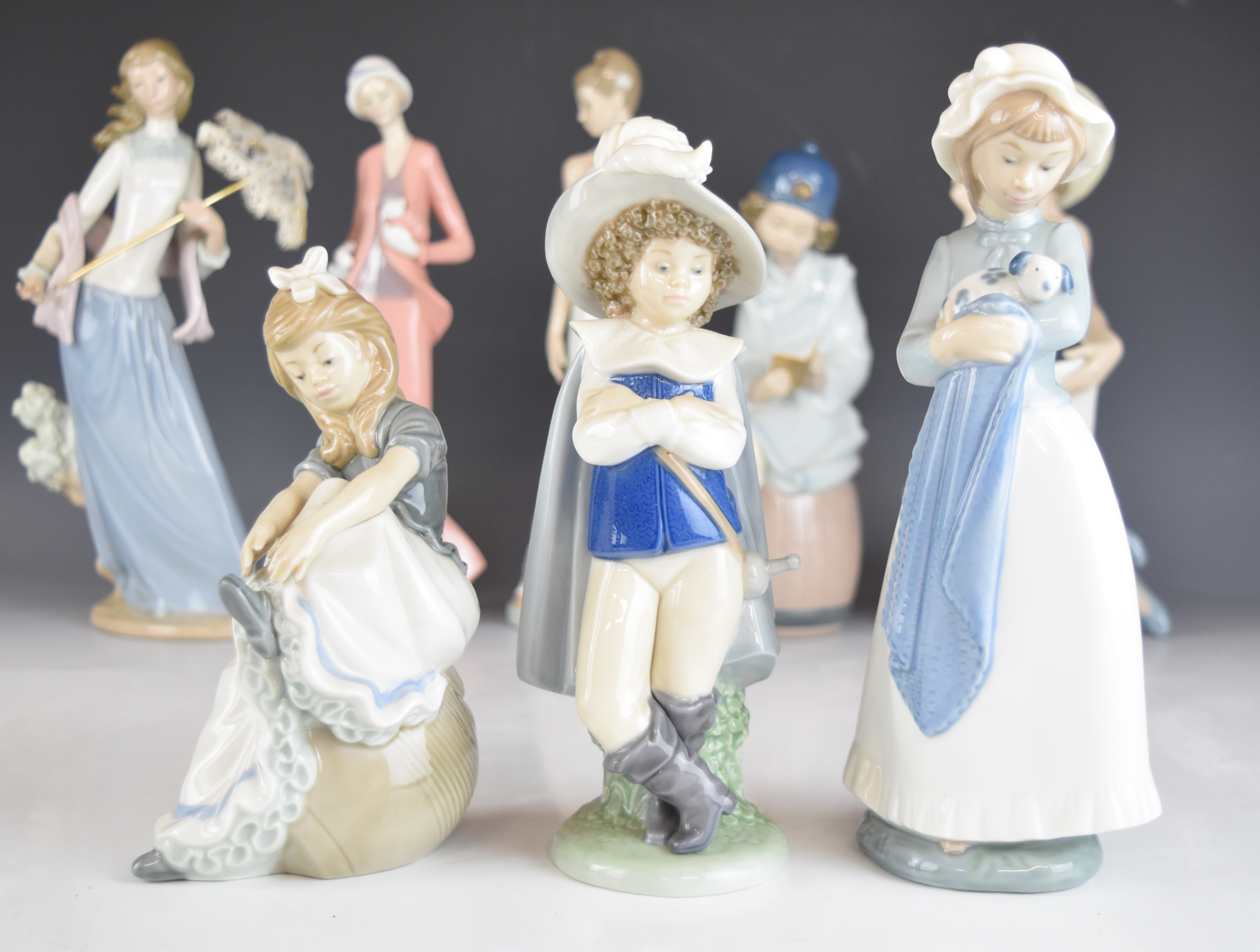 A collection of Lladro and Nao figurines and an advertising stand, tallest 32cm - Image 11 of 14