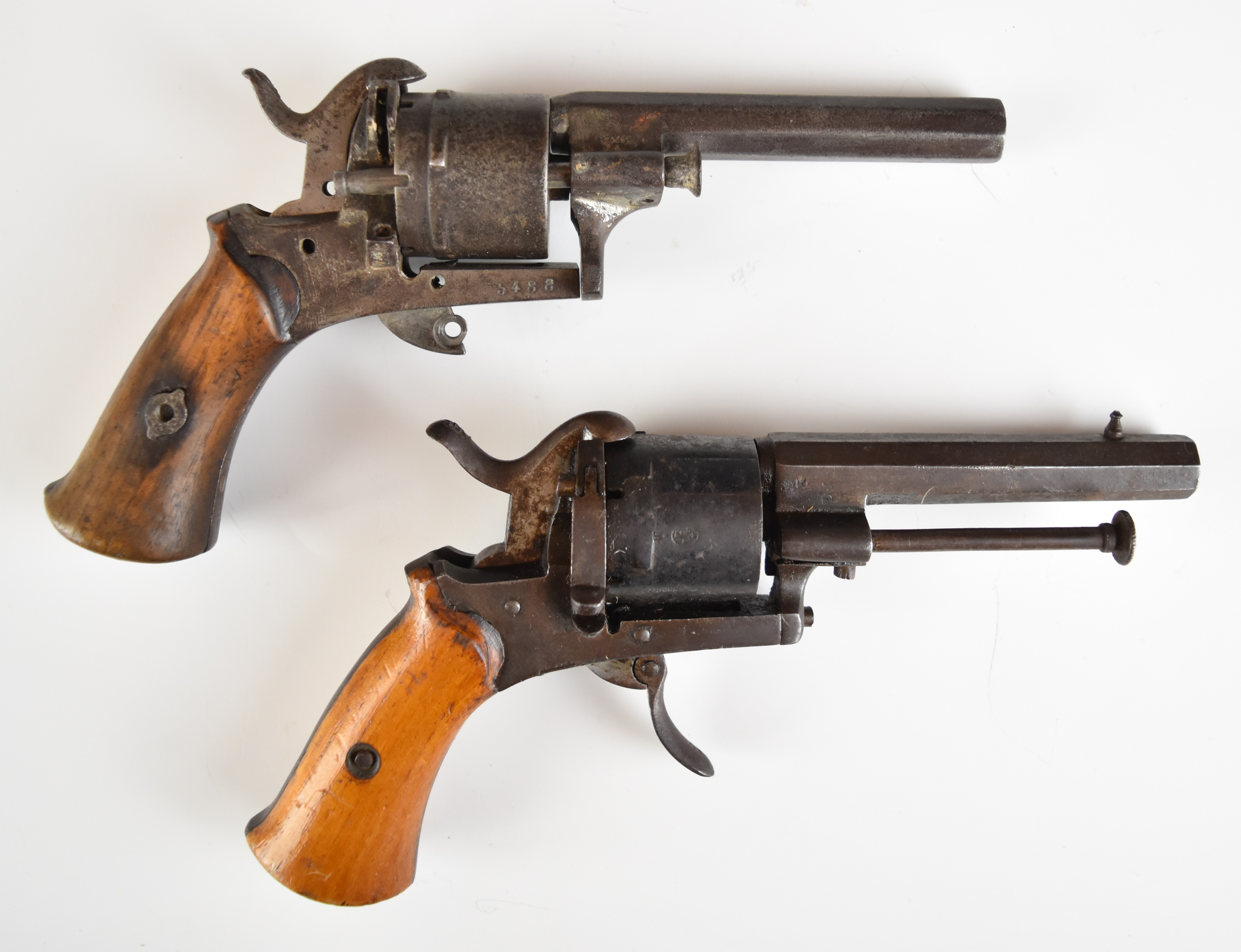 A composed pair of Belgian six-shot pinfire double-action revolvers, each with shaped wooden grips