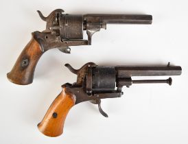 A composed pair of Belgian six-shot pinfire double-action revolvers, each with shaped wooden grips