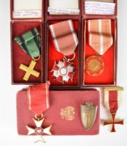 Four boxed Polish WW2 medals comprising The Order Of Polonia, Partisans Cross, Cross of Merit and