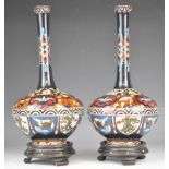 A pair of Chinese cloisonné vases on hardwood stands, height 35cm with stands