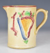 19thC Irish pottery jug with relief moulded decoration of a harp and an Irish Wolfhound with flag,
