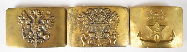 Three Russian brass belt buckles including Infantry and Navy examples