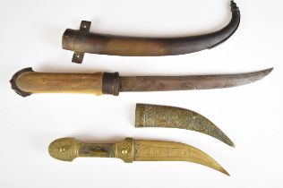 Two Jambiya daggers, the larger example with bone or similar grip and 22.5cm blade, the other of
