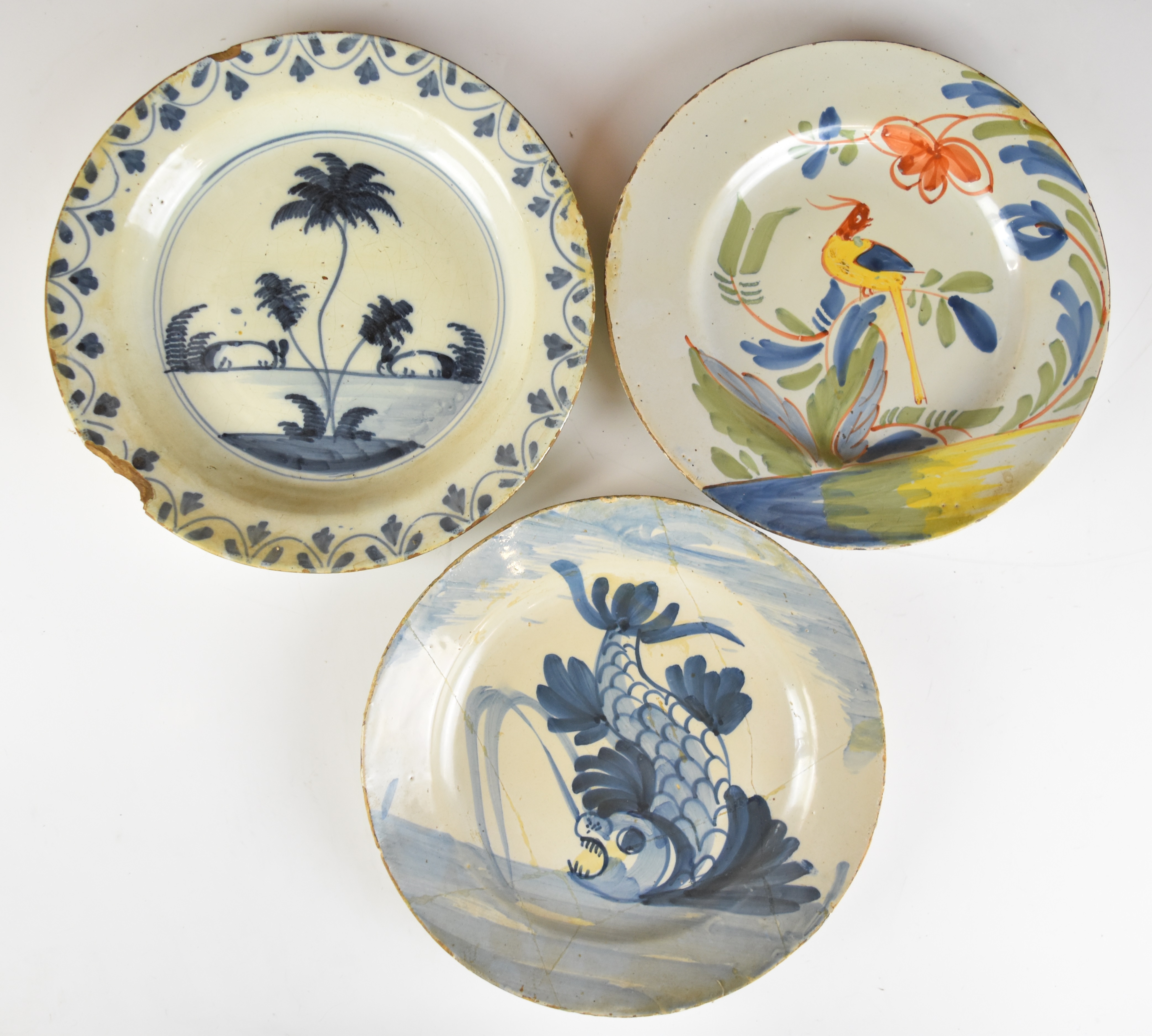 Three 18thC Delft plates including a polychrome example with exotic bird decoration, largest