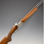 Browning B2 12 bore over and under shotgun with engraved scenes of birds to the locks and underside,