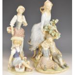 Three Lladro figurines including a lady with children, tallest 29cm
