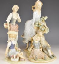 Three Lladro figurines including a lady with children, tallest 29cm