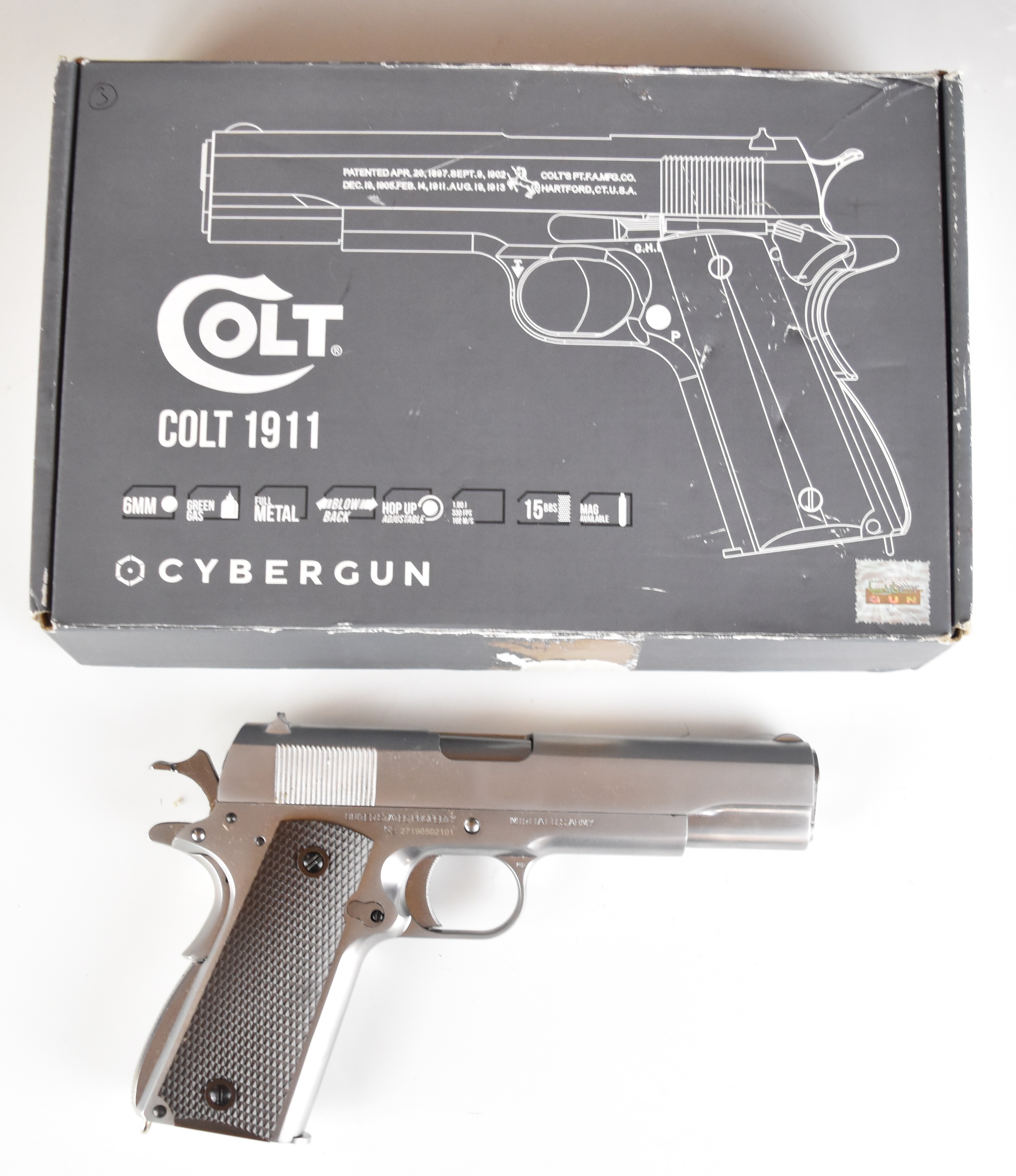 Cybergun Colt 1911 6mm CO2 airsoft pistol with chequered faux wooden grips, multi-shot magazine