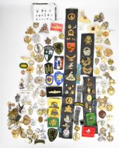 Large collection of approximately 100 overseas forces badges including South Africa, France, Canada,