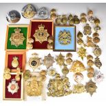 Collection of approximately 40 British Army badges for Glengarry, bearskin and other headwear