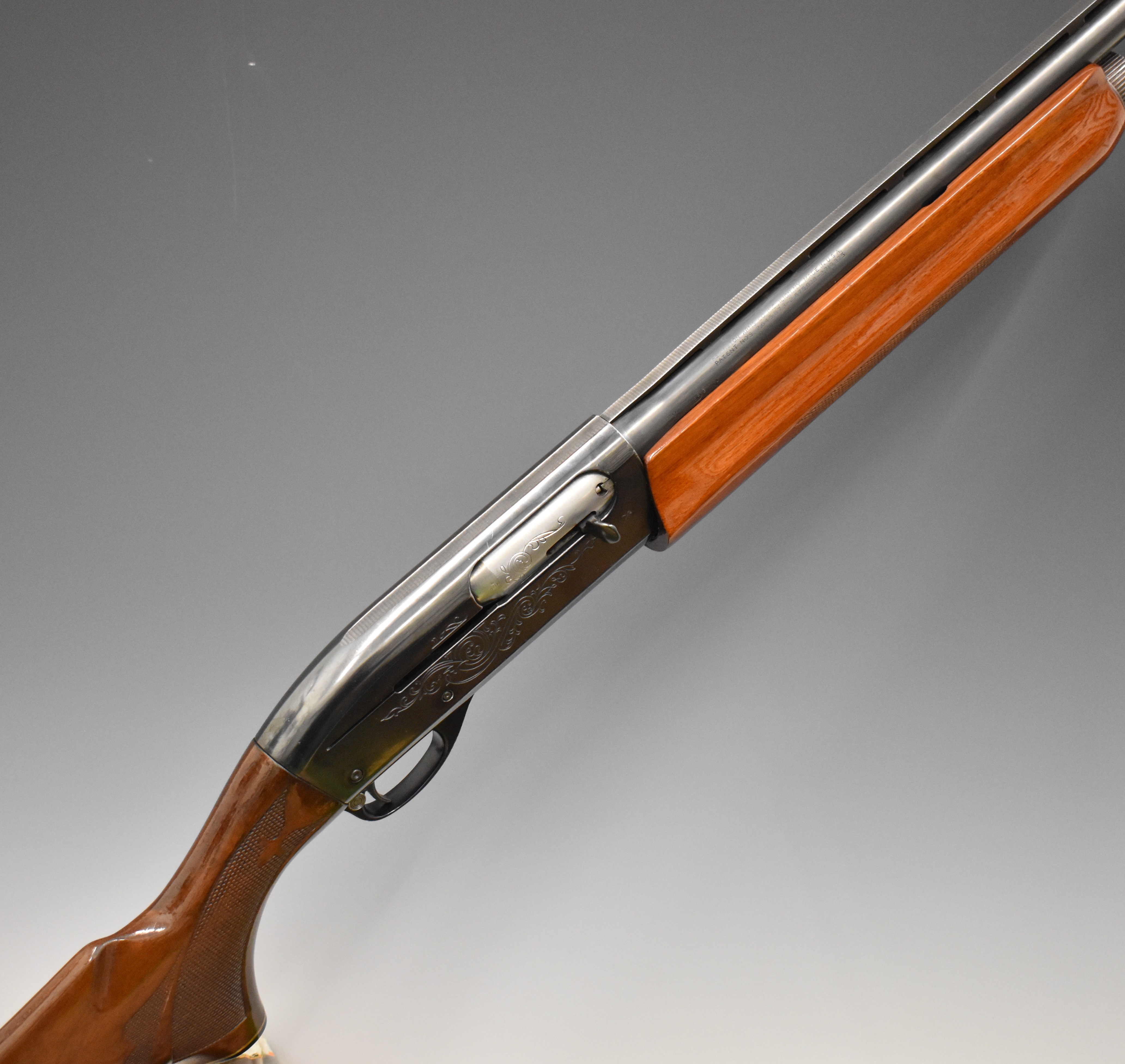 Remington Model 1100 12 bore 3-shot semi-automatic shotgun with ornately carved and chequered semi-
