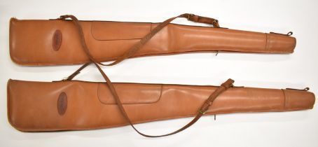 A pair of Parker & Son brown leather shotgun or rifle slips with shoulder straps, each 129cm long.