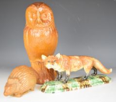 Salt glazed stoneware figures of an owl and a hedgehog and a figure of a fox with spongeware style