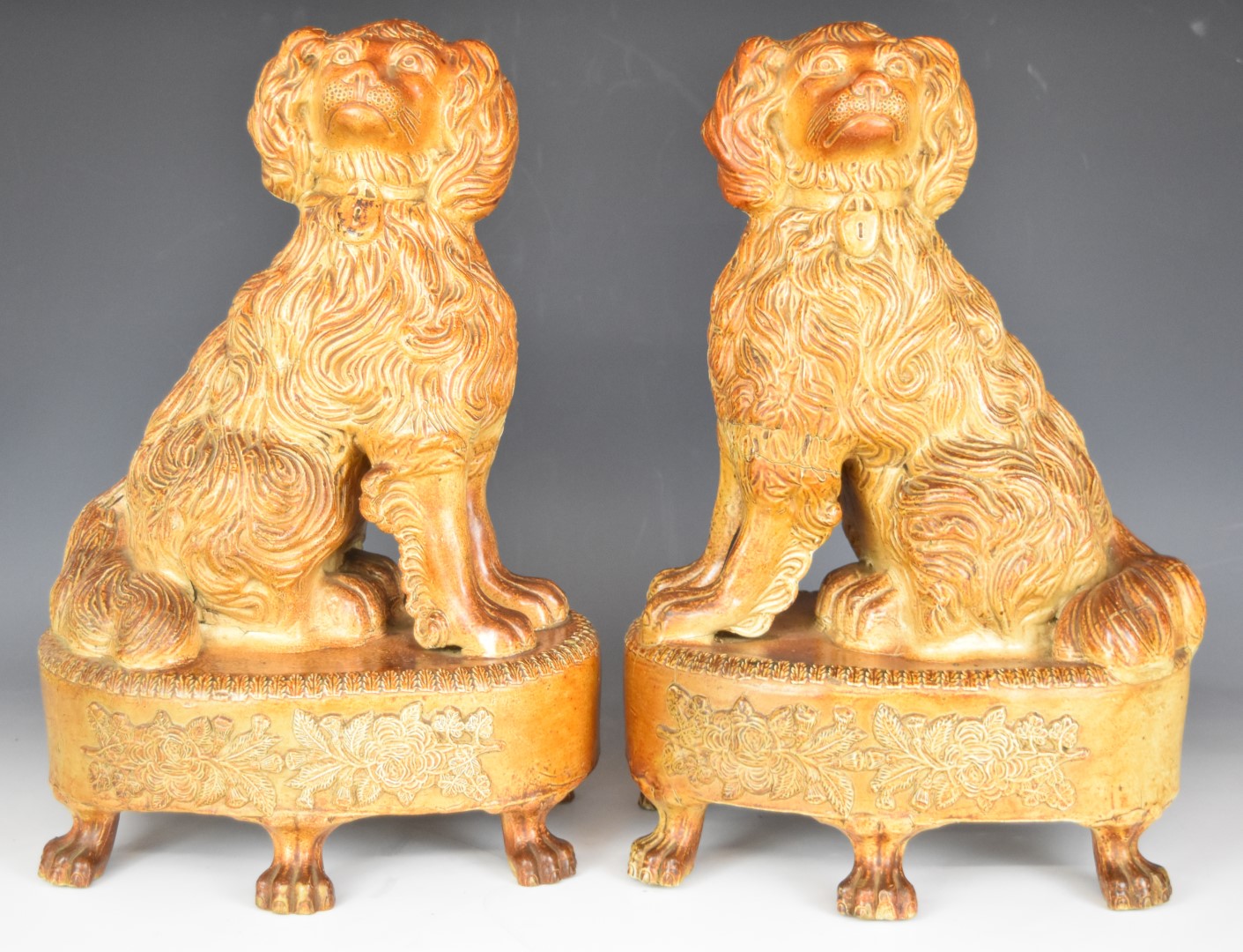 Pair of 19thC S and H Briddon, Brampton brown salt glazed stoneware spaniels / dogs with padlock
