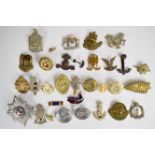 Collection of approximately 25 military cap badges including British Asia slouch hat badge, 22nd