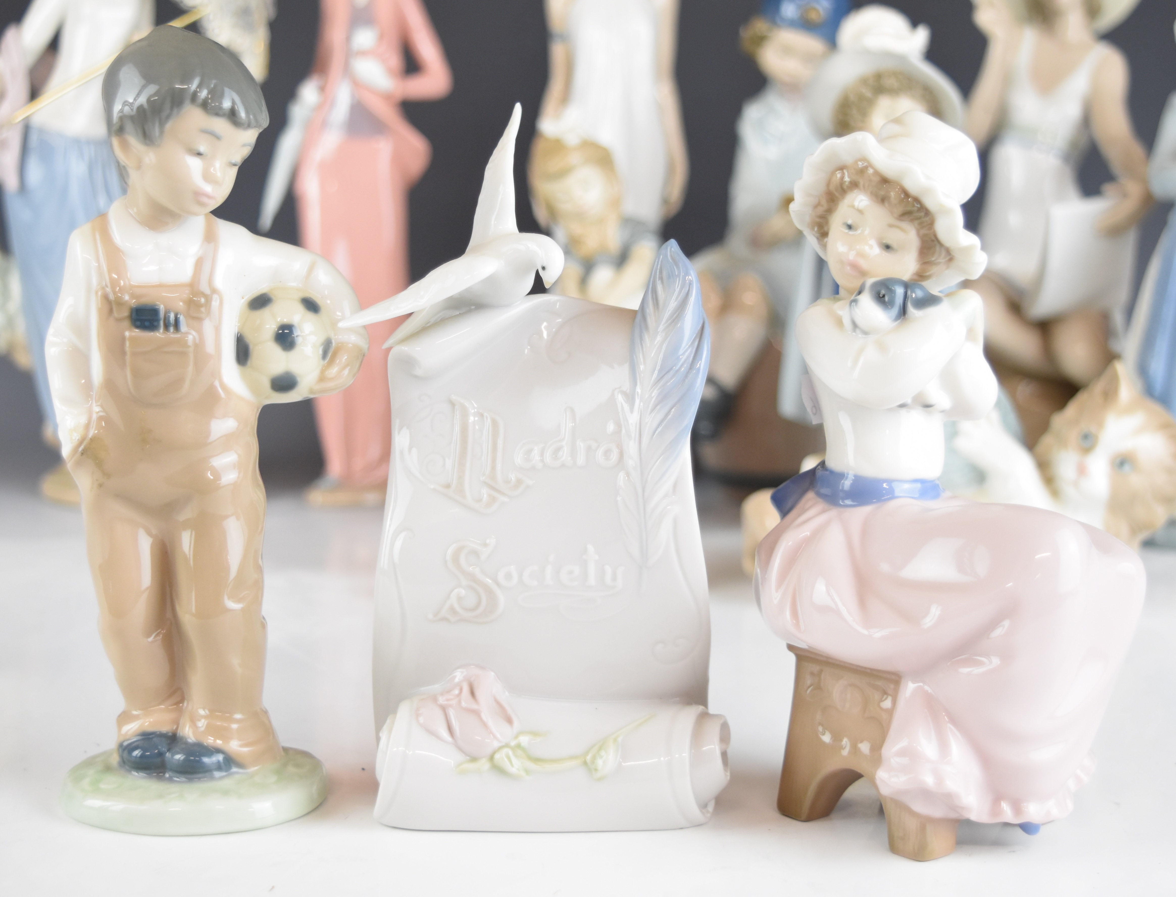 A collection of Lladro and Nao figurines and an advertising stand, tallest 32cm - Image 9 of 14