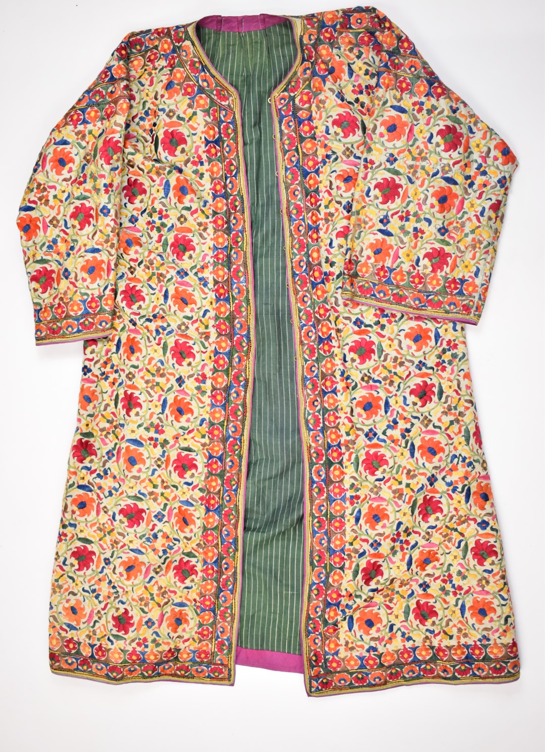 19th / 20thC Indian embroidered coat or coat dress, with a note stating the coat was gifted in the
