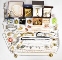 A collection of jewellery including Swarovski brooch, French jet necklace, Kirks Folly charm