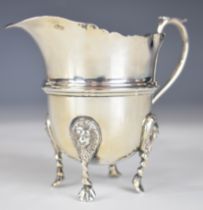 Edward VII hallmarked silver jug raised on four lion mask feet, Birmingham 1910, maker William