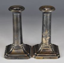 Pair of George V hallmarked silver candlesticks with cylindrical columns and square bases with