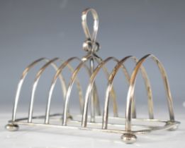 Victorian hallmarked silver seven bar toast rack raised on four bun feet, Chester 1898, maker John