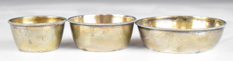 Set of three Austro Hungarian silver bowls with beaded edges and gilt interiors, all with 800