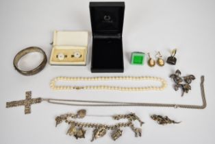A collection of silver jewellery including charm bracelet with eight silver charms, Swedish brooch