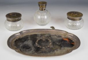 George V hallmarked silver, tortoiseshell and glass dressing table set comprising tray, bottle and