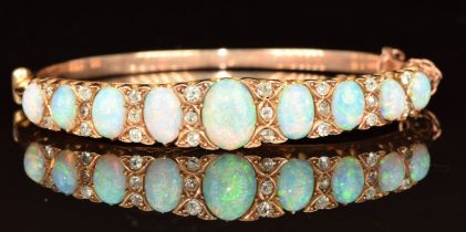 An 18ct gold Victorian bangle set with nine graduated oval opal cabochons (largest opal 1.2ct,