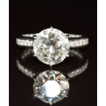 An 18ct white gold ring set with a round cut diamond of approximately 2.8ct, with diamond