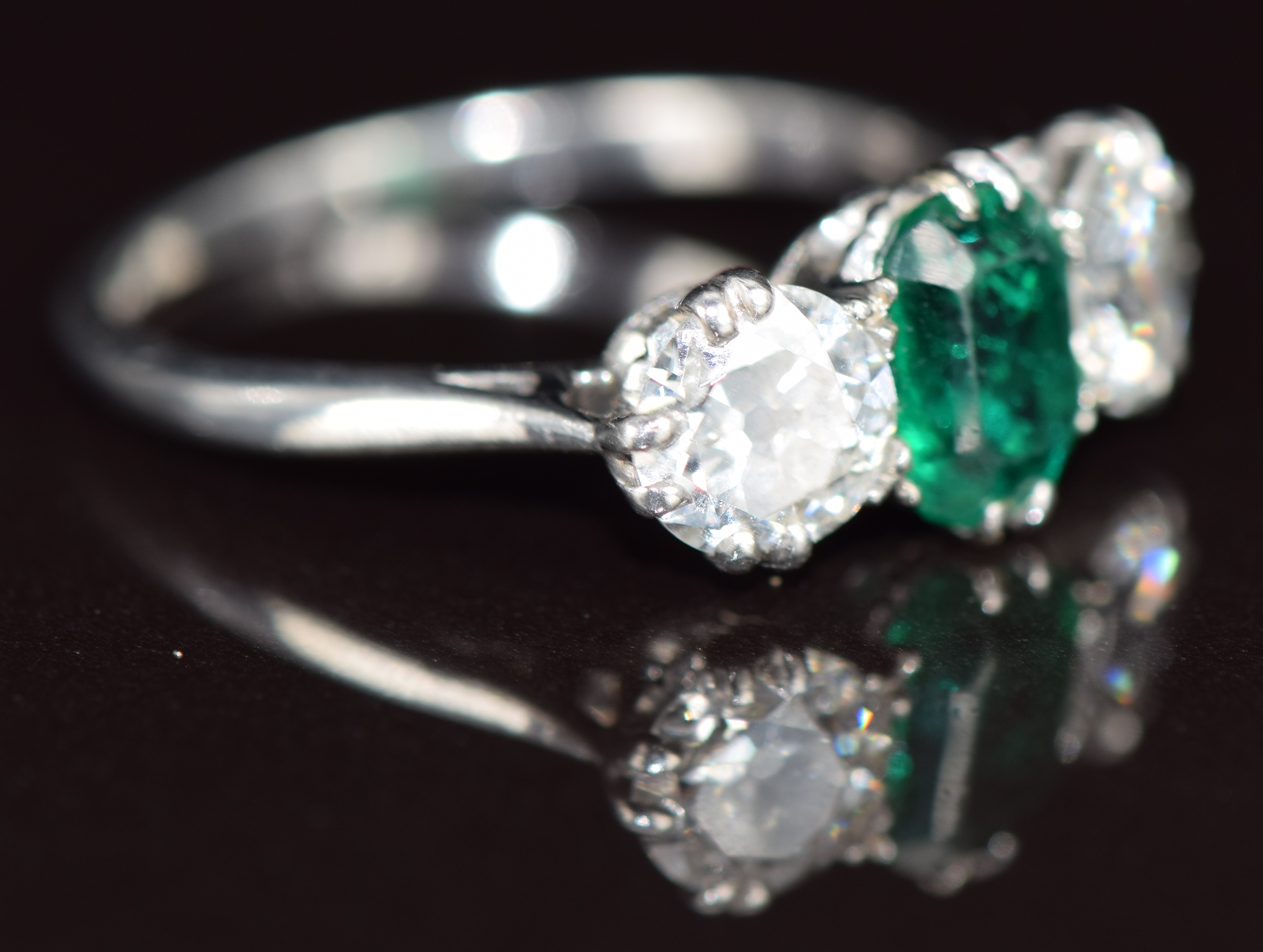 A platinum ring set with an emerald cut emerald of approximately 1.1ct and two old cut diamonds of - Image 3 of 3