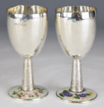 Pair of Elizabeth II Bert Gordon hallmarked silver and white and floral guilloché enamel goblets,
