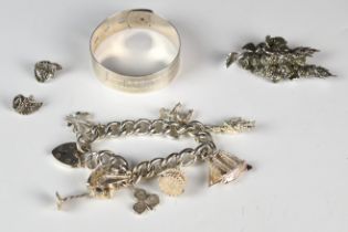A hallmarked silver bangle by Charles Horner (Chester 1945), silver charm bracelet with eight silver