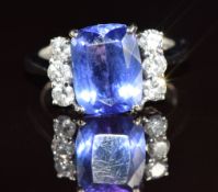 An 18k white gold ring set with a radiant cushion cut tanzanite of approximately 3.5ct and six