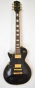 Gould Les Paul style left handed electric guitar, with black finish and gold hardware.