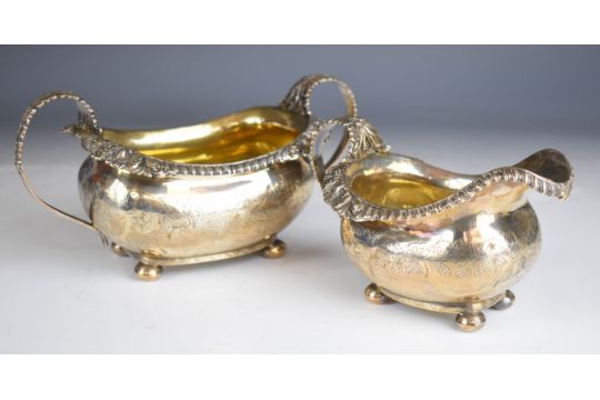 Georgian hallmarked silver milk jug and matching sugar bowl both raised on four ball feet, milk - Image 1 of 9