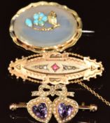 Edwardian brooch set with heart cut amethysts surrounded by seed pearls (4cm), a Victorian brooch