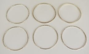 Six silver bangles with various textured finishes, 54g