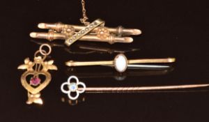 Two 9ct gold brooches, one set with seed pearls and the other an opal, a 9ct gold stick pin set with