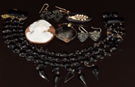 A collection of Victorian jet jewellery including two pairs of earrings, brooch and necklace